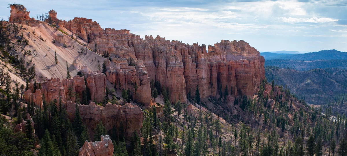 4+ hour summer banner Spiky, jagged red rock formations from above.