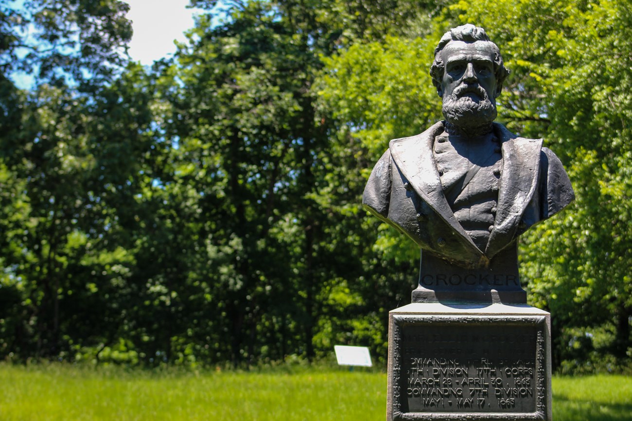 A bronze bust sculpture of a man in uniform