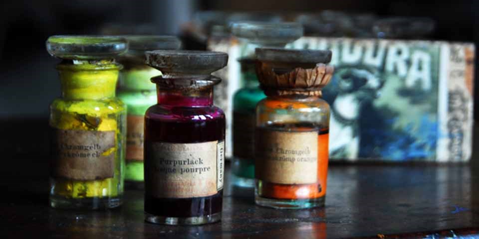 A group of colorful paint bottles on a table.