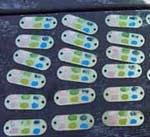Brass tags painted with heat sensitive paint.