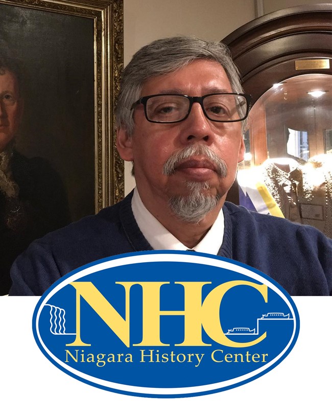 A man with glasses and a goatee, underneath is the logo for the Niagara History Center.