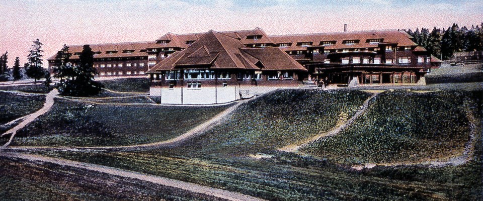 A 4- or 5-story hotel built into a hill with multiple roads leading to it