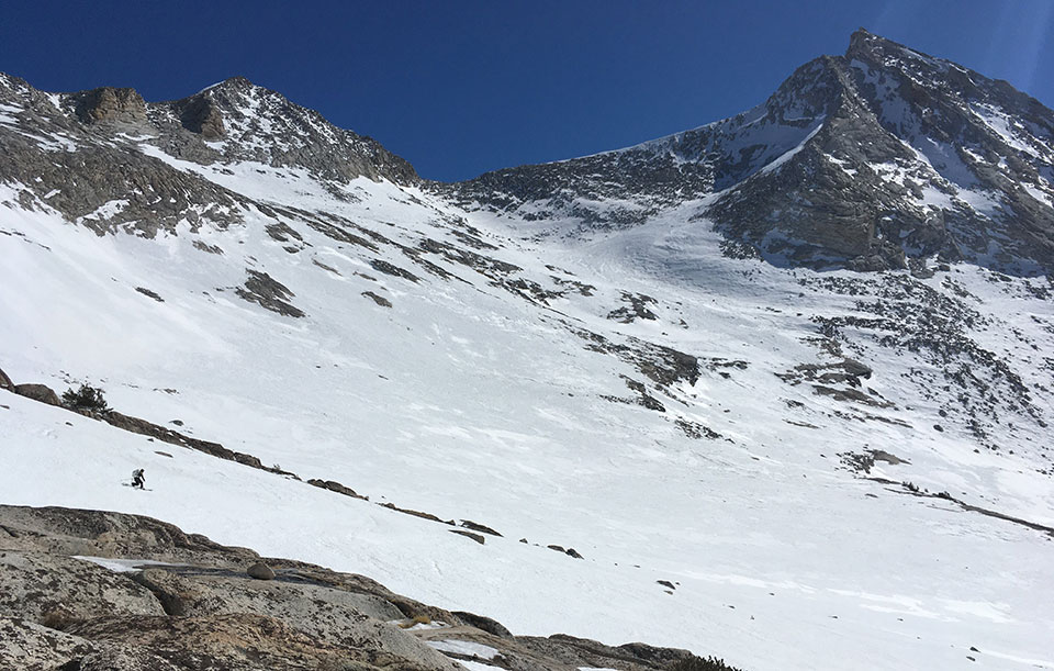 Skier in the shadow of Mt. Conness on February 19, 2022.