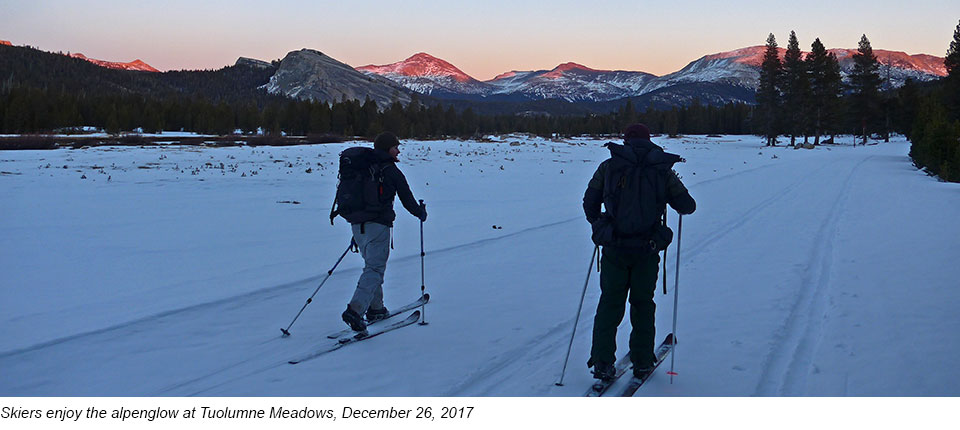 Skiers enjoy the alpenglow at Tuolumne Meadows, December 26, 2017