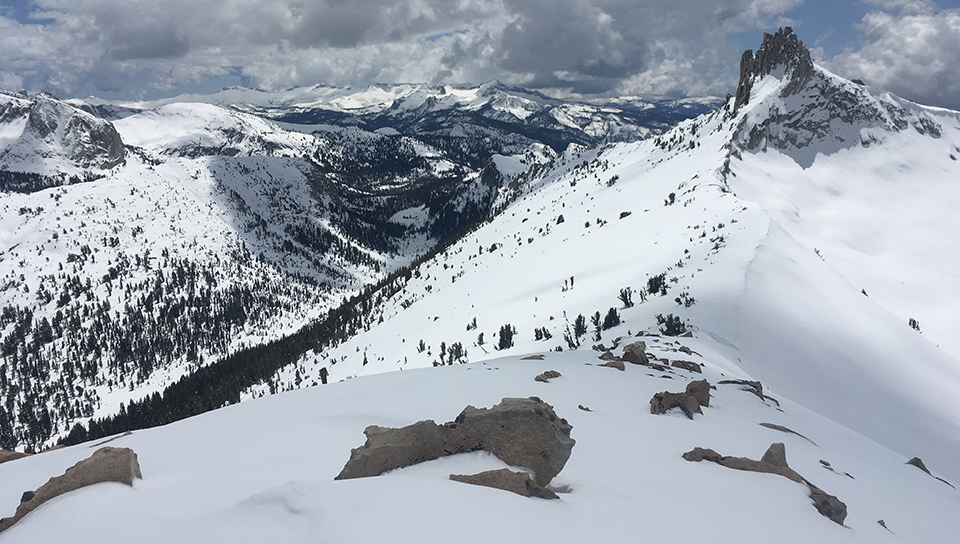 Cockscomb (a mountain near Tuolumne Meadows) rises above the snow on a partly cloudy day on April 21, 2020.