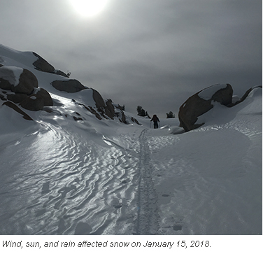 Skier on wind and sun affected snow