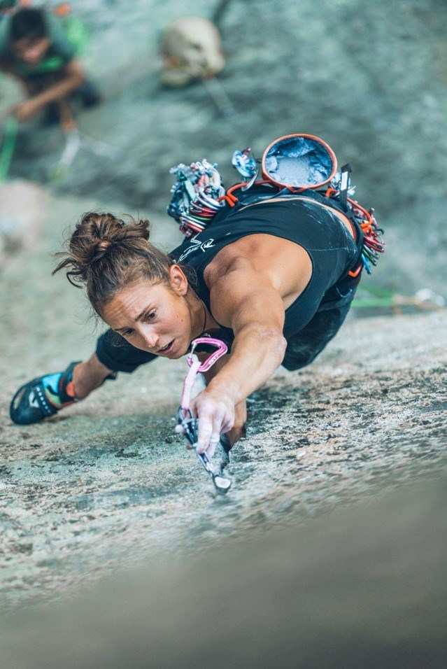 Looking down a big wall at a woman placing protection