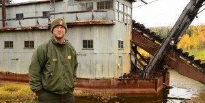 Park Ranger standing in front of the Coal Creek Dredge