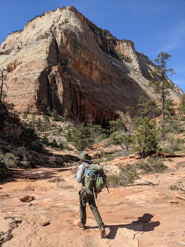 ranger approaching mountain of the sun